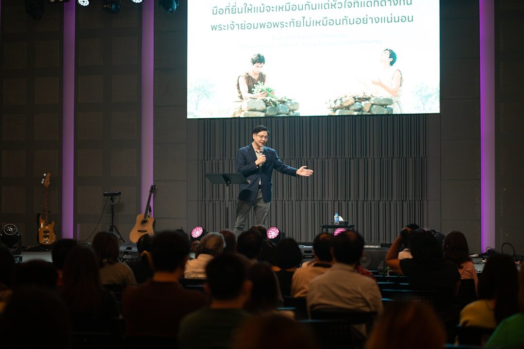 Speaker presenting to an audience of business professionals at a conference