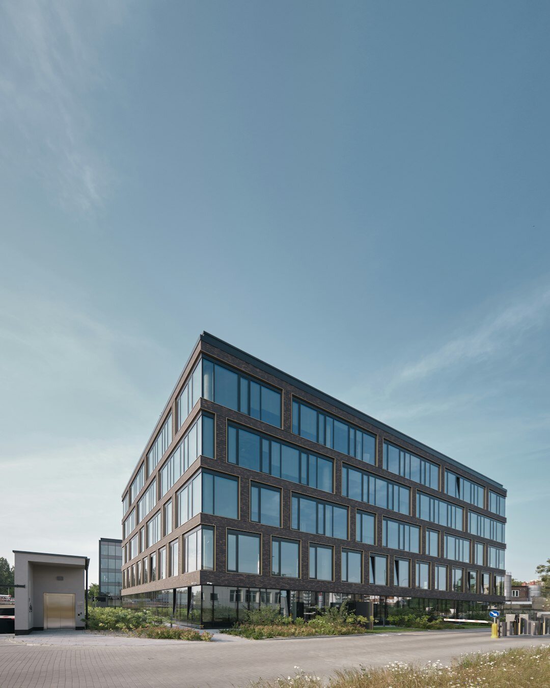 Modern glass office building exterior in a Belgian business district