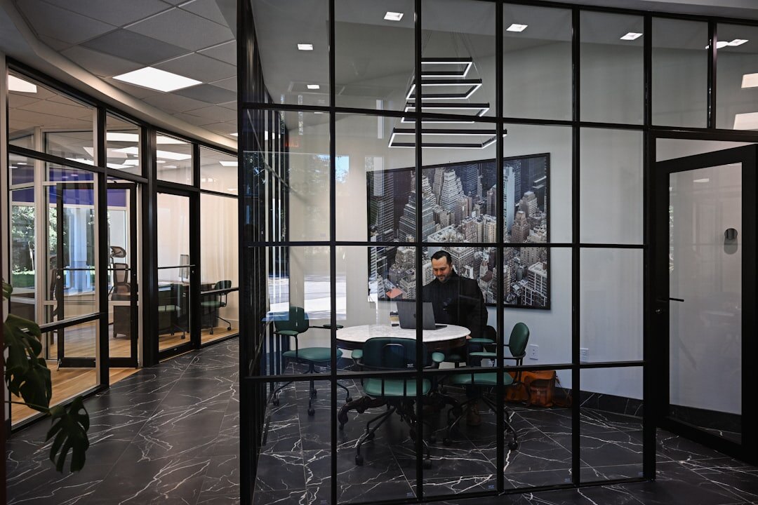 Modern glass meeting room with business people discussing around a table